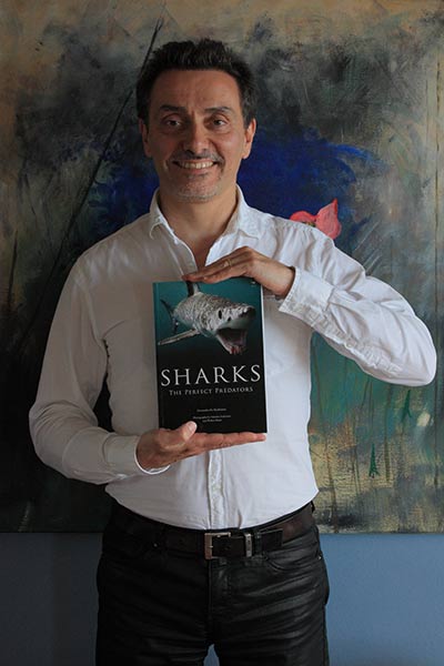 Alessandro De Maddalena showing one of his many shark biology books, "Sharks - Perfect Predators", published by Jacana Media in South Africa (photo by Alessandro De Maddalena / Alessandra Baldi).